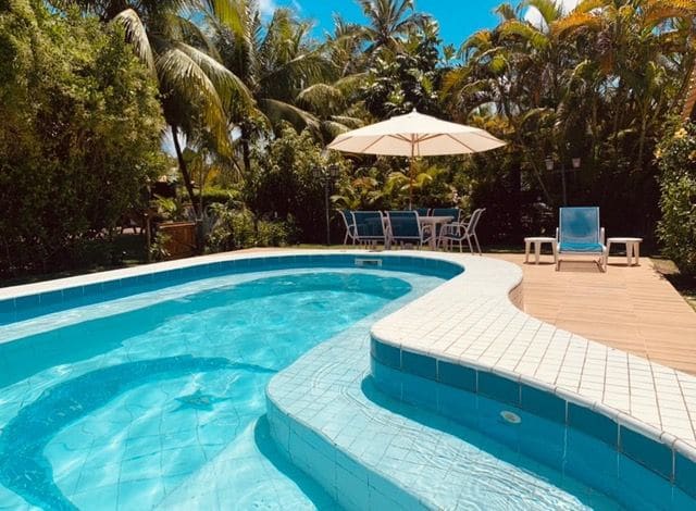 Pool with sun loungers and umbrella
