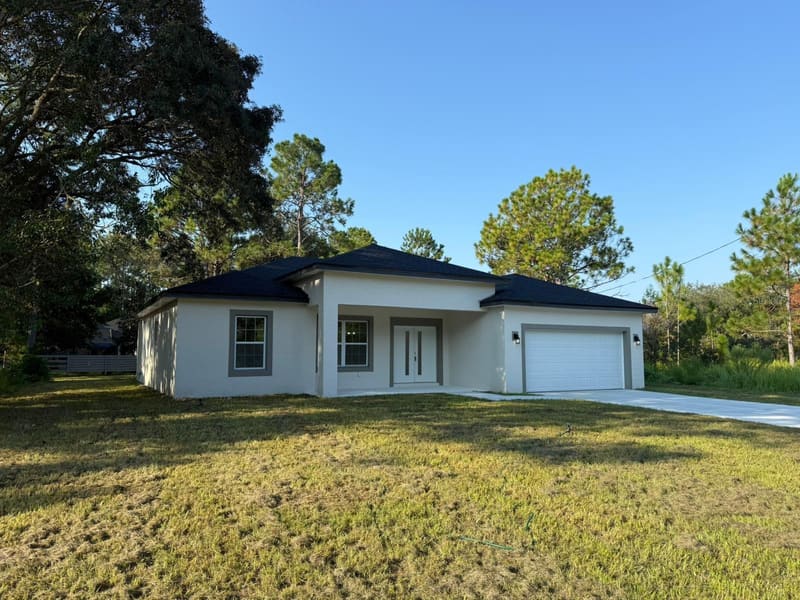 Home and driveway on a wooded lot
