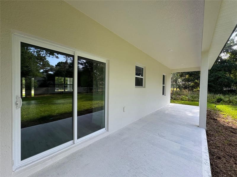 Covered rear porch with sliding glass door